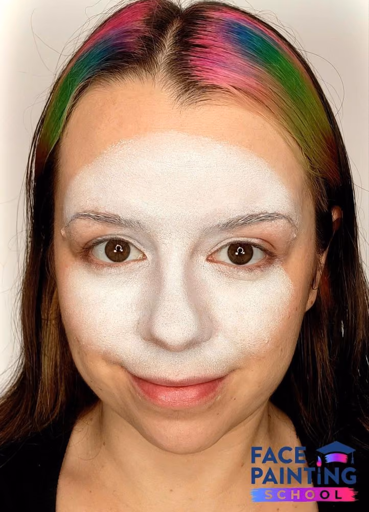 a girl with a white panda face painting base