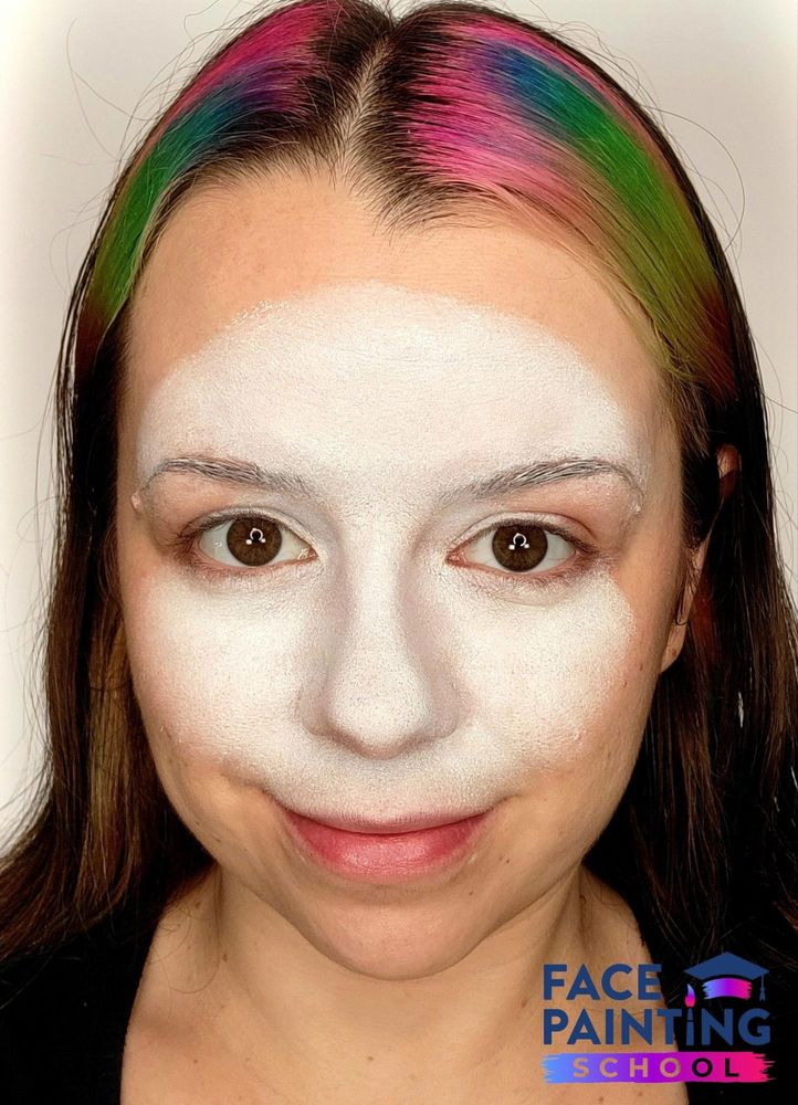 a girl with a white panda face painting base