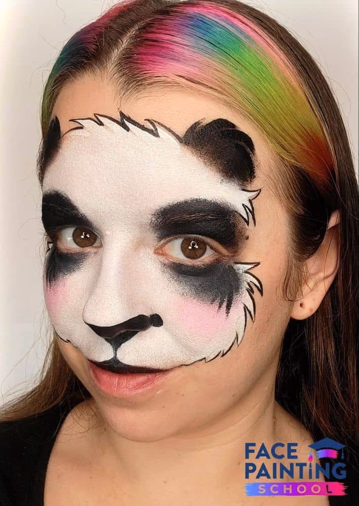 a girl with an harder outlined panda face painting