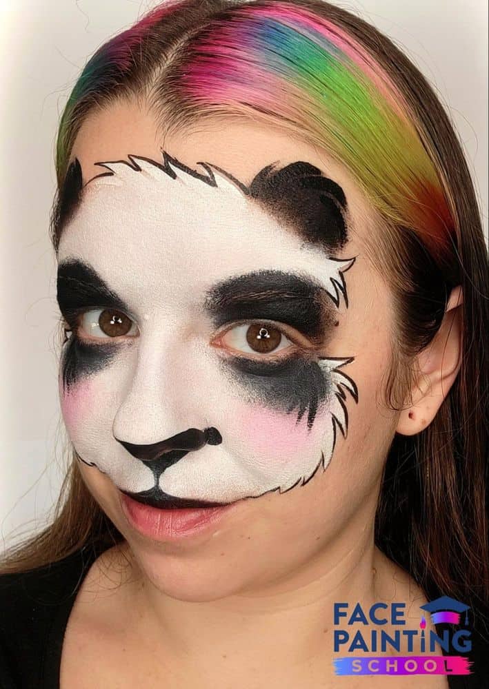 a girl with an harder outlined panda face painting