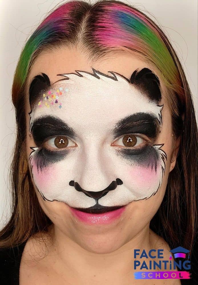 a girl with an outlined panda face painting