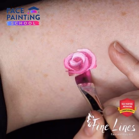 miniature minimalistic rose done in five strokes of a face painting brush