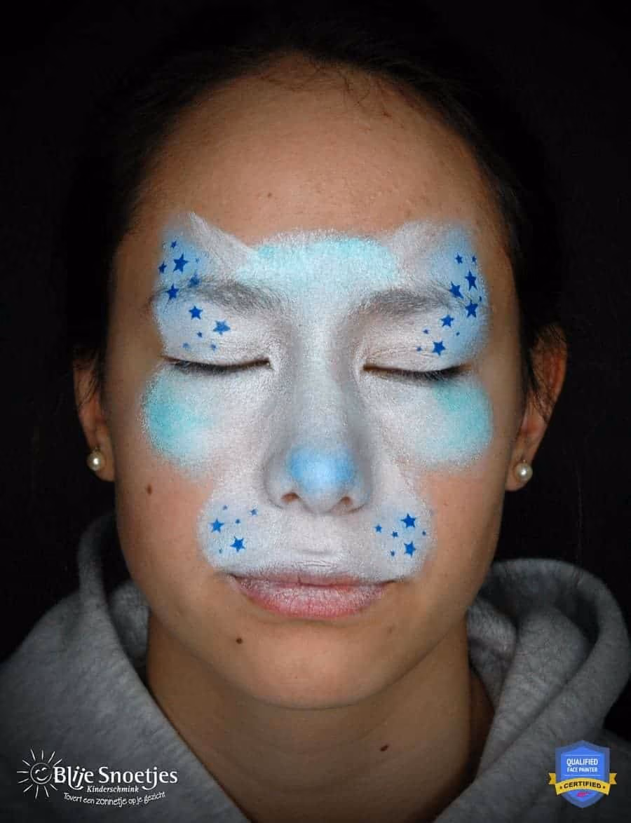 girl with a kitty cat face paint base put on her