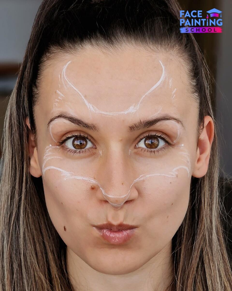 a girl with a white outline of a fox face pace paint design