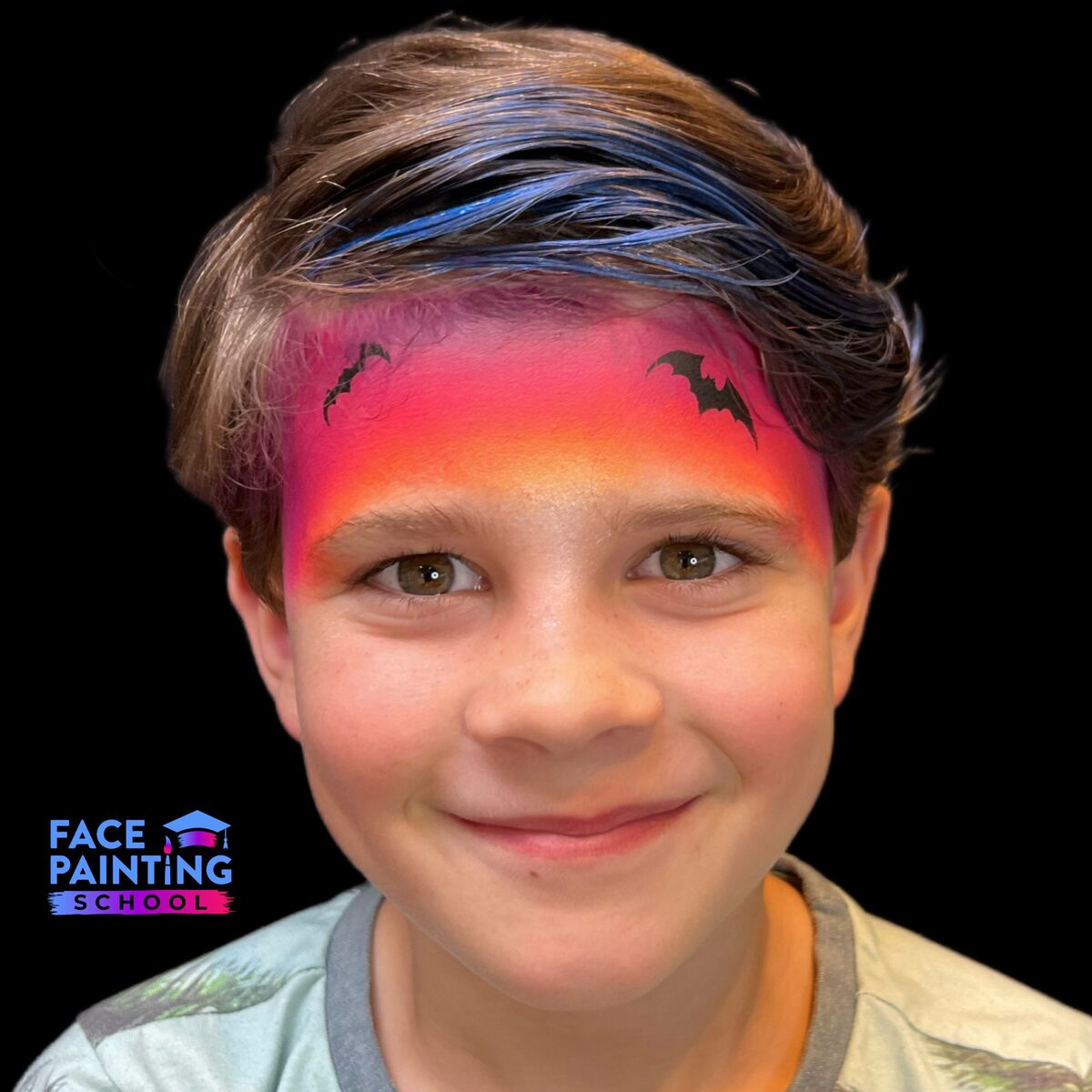 a boy with gradient red to yellow face paint on his forehead and two bats painted