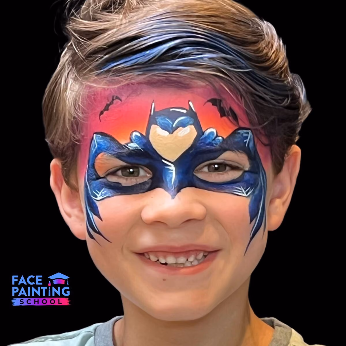 boy with a batman mask face paint over his face looking at the camera and smiling