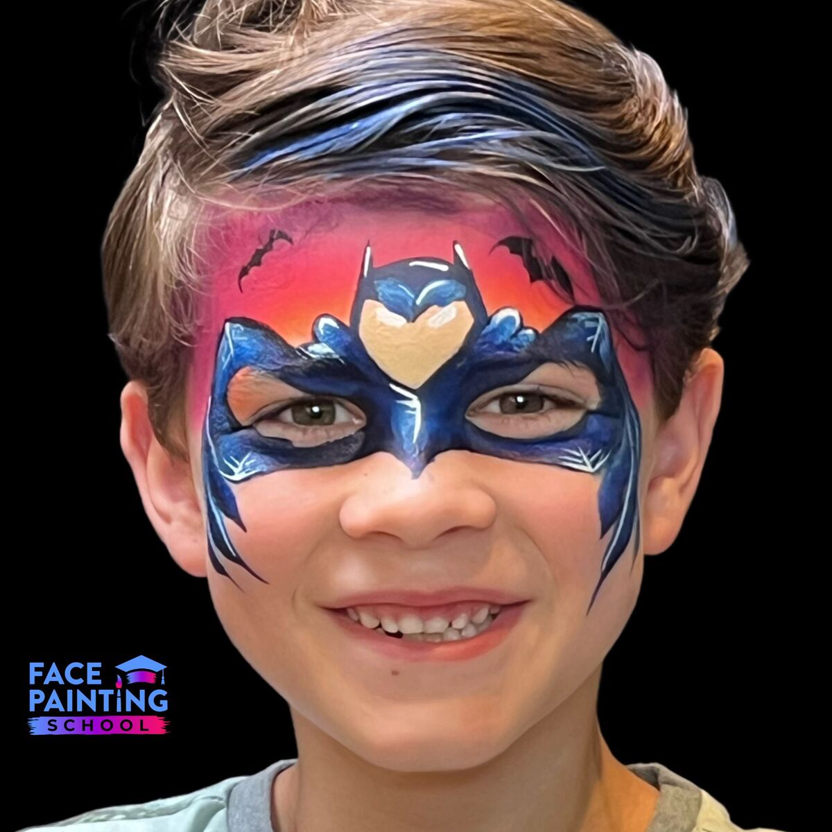 boy with a batman mask face paint over his face looking at the camera and smiling