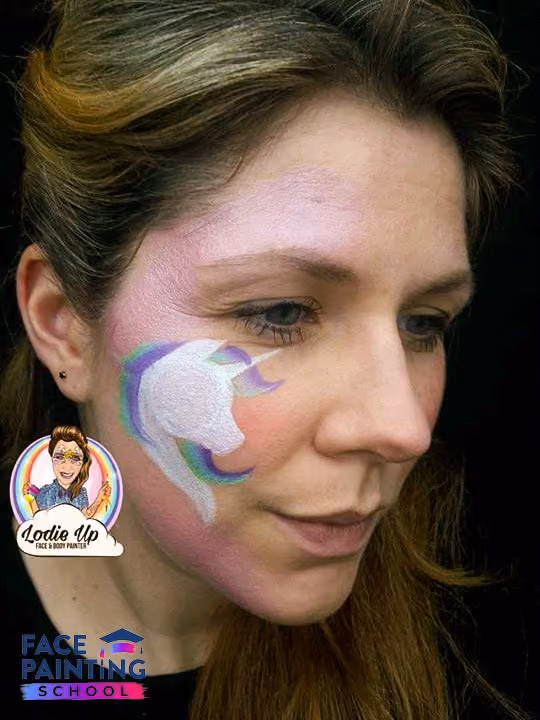 a woman with an filled white outline of a unicorn face paint design on her