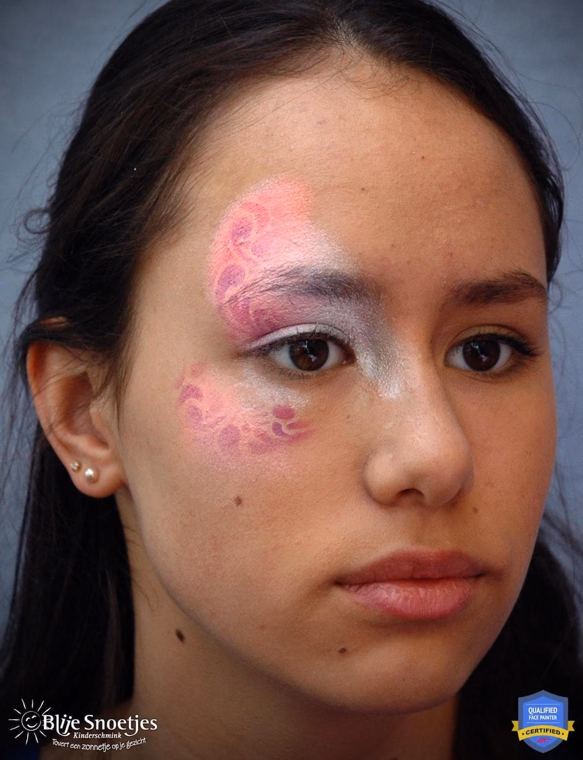 a woman with a base of a fancy eye face paint design