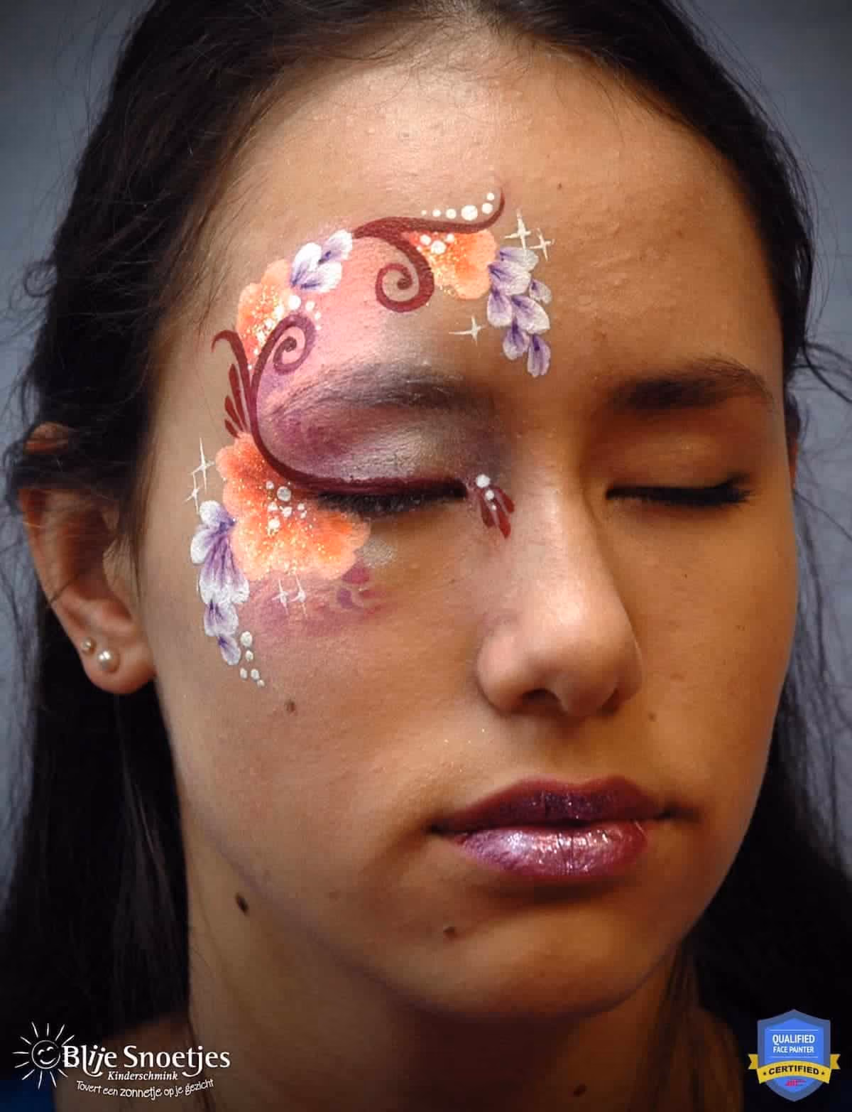 a woman with her eyes cloded wearing a compleated fancy eye face paint design
