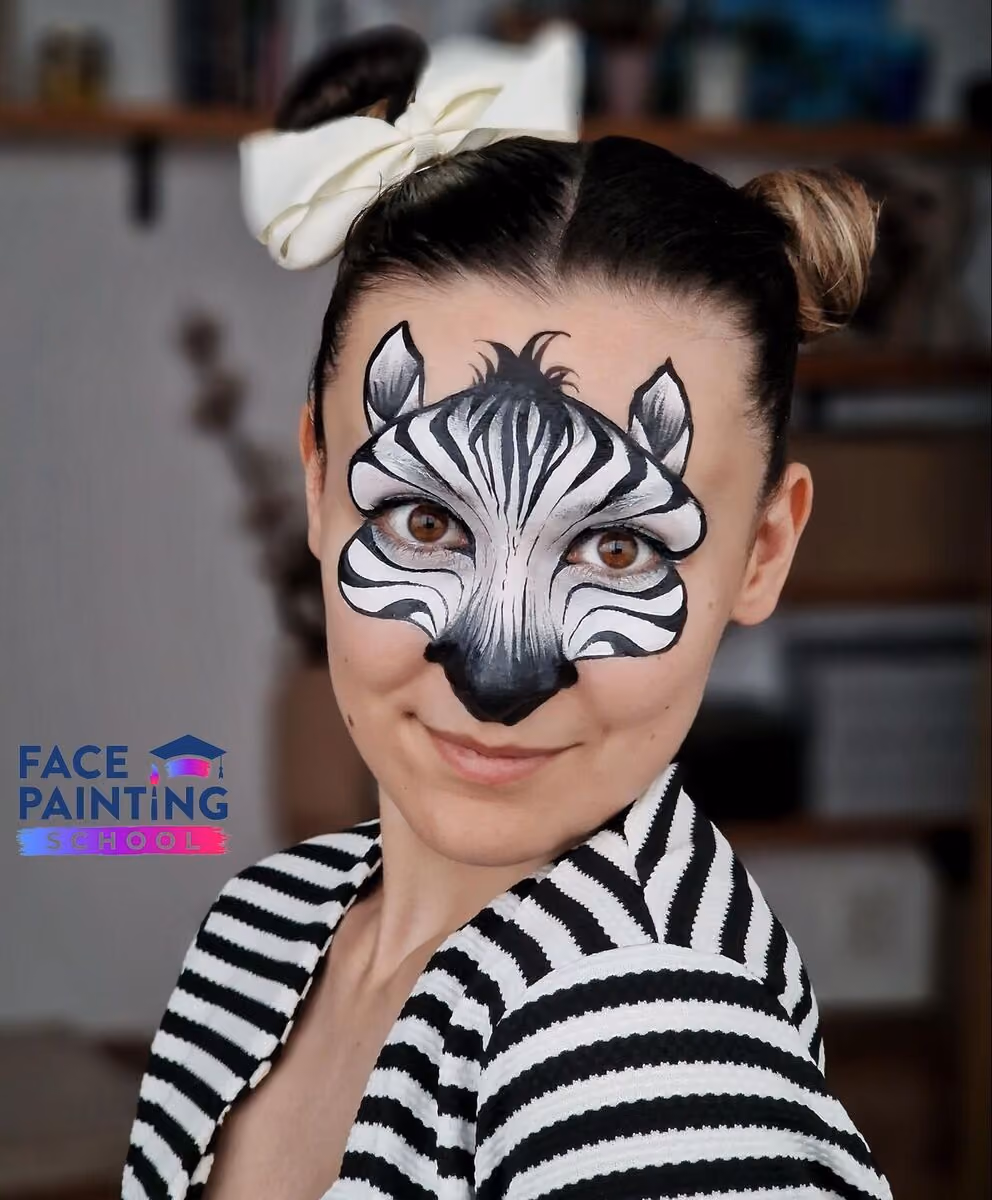a shot of a woman looking at the camera at an angle with a zebra face paint design on her face