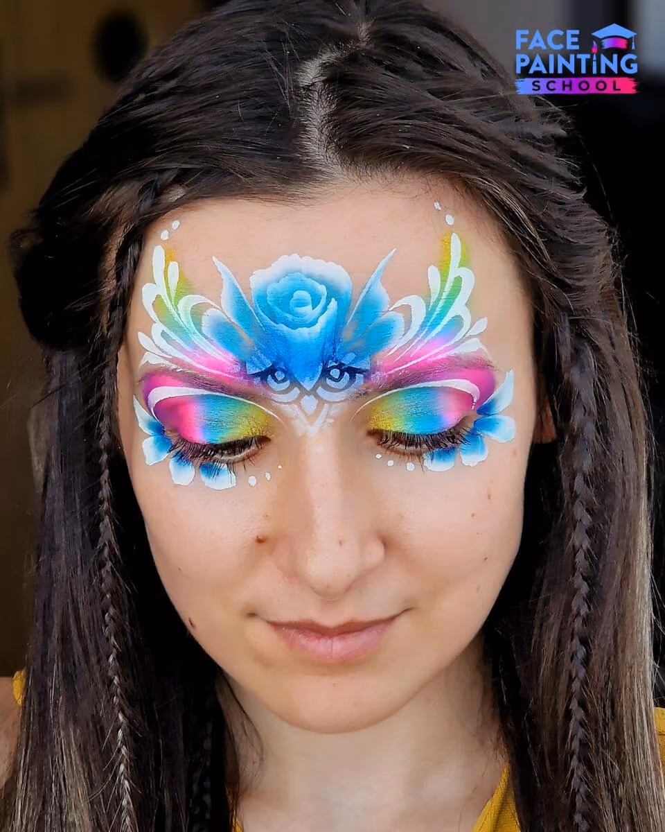 a girl looking down while wearing a fairy face paint design