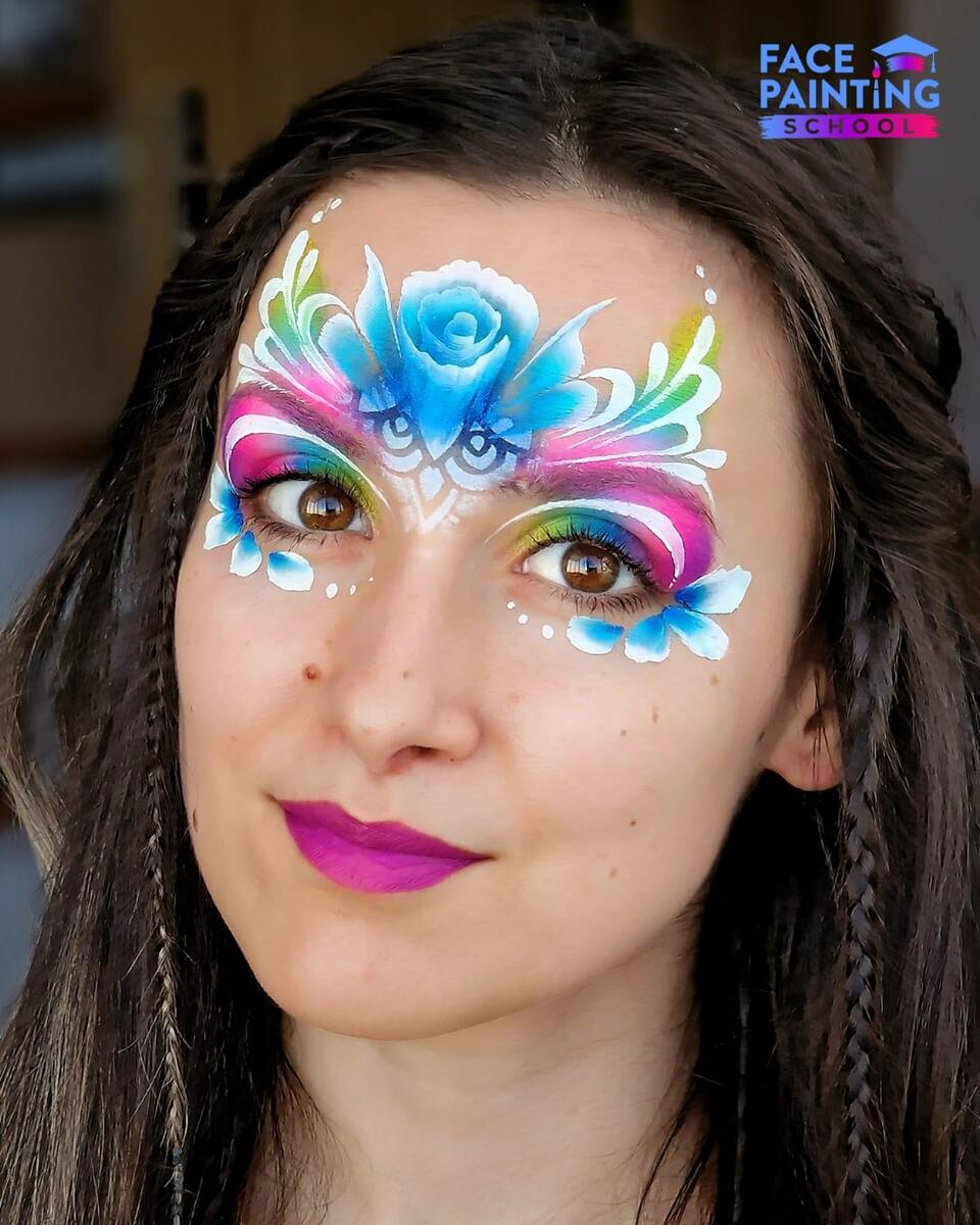a woman with a compleated fairy face paint design on her