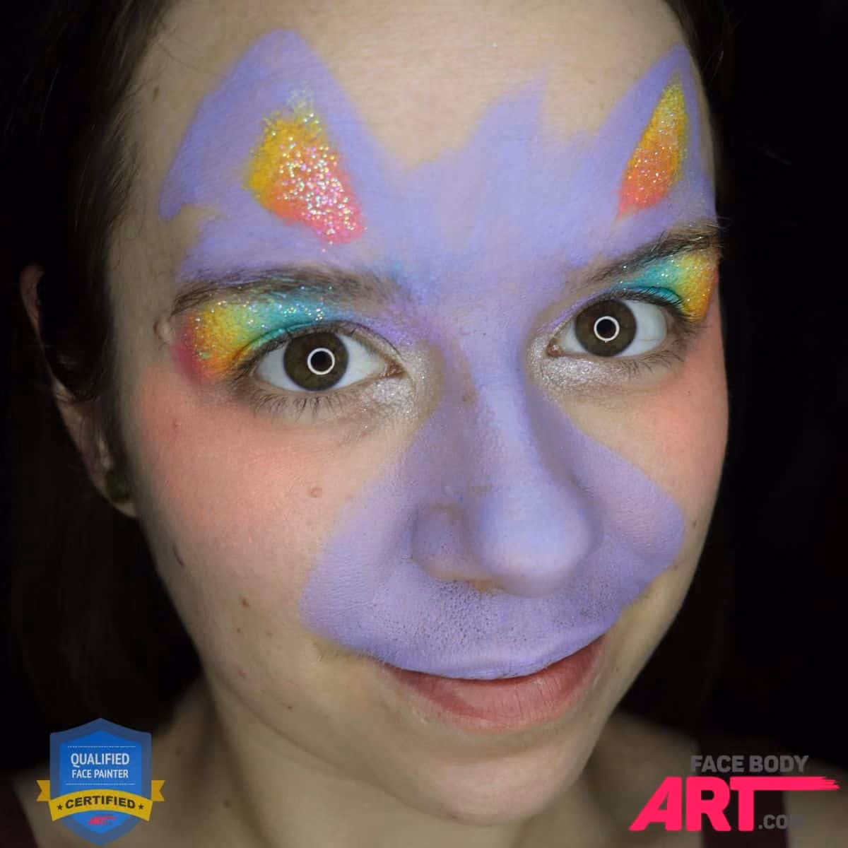 a girl with a base of a bunny face paint and gradient eye shadow and filled bunny ears