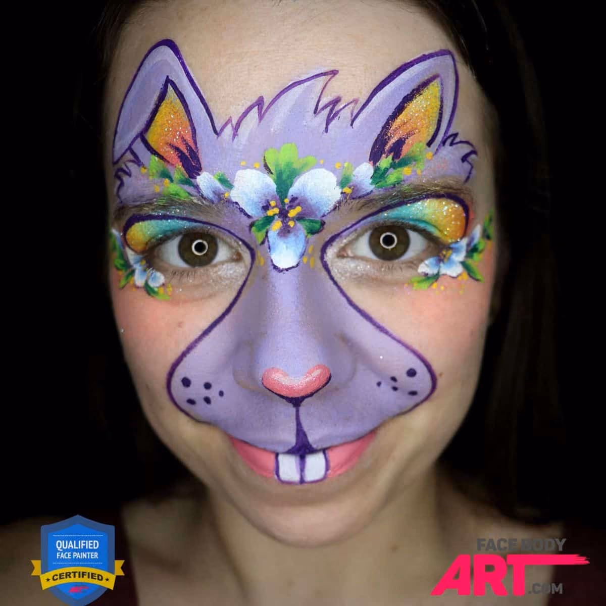 a girl with a compleated bunny face paint desing over her face