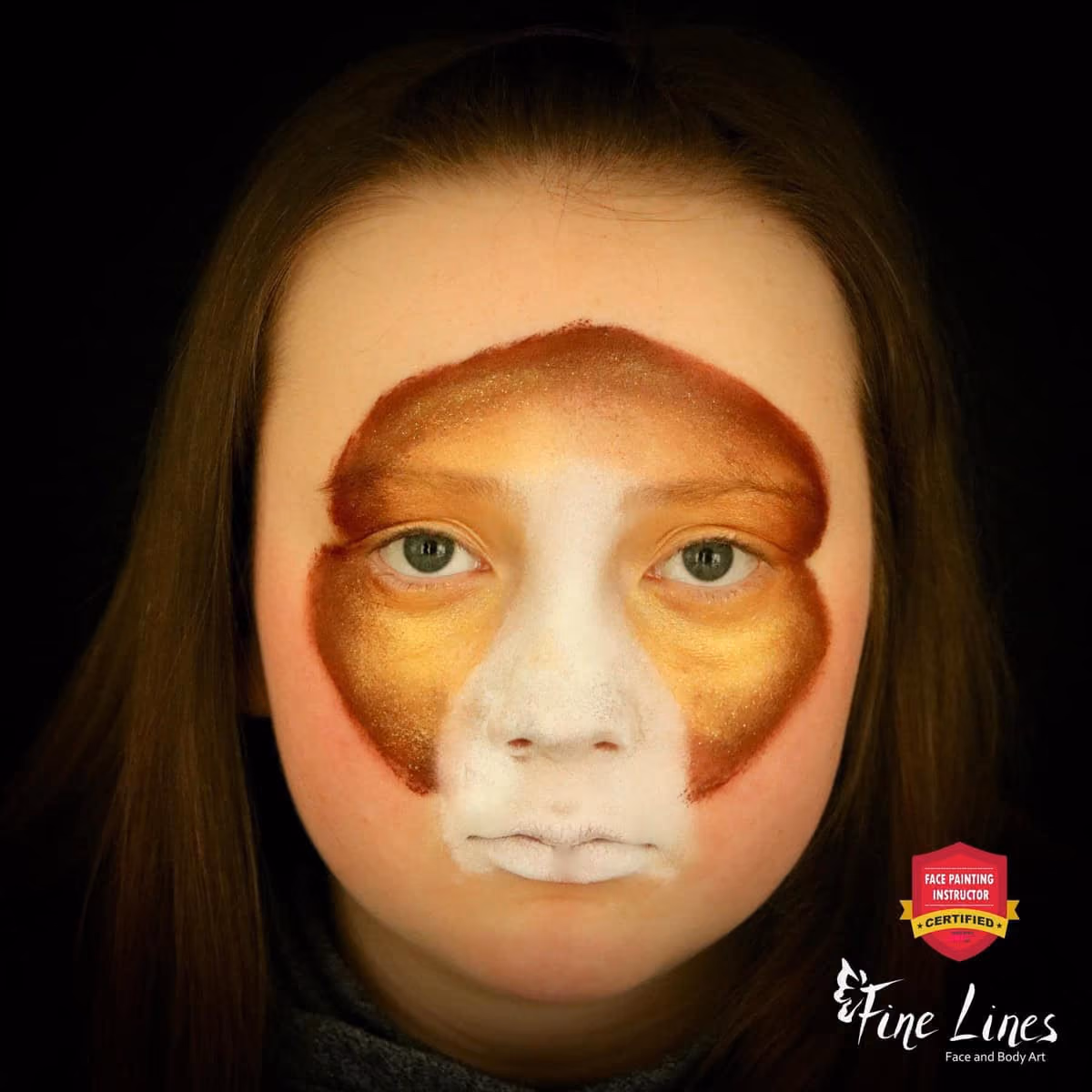 girl looking at the camera with brown face paint around the golden paint on her eyes