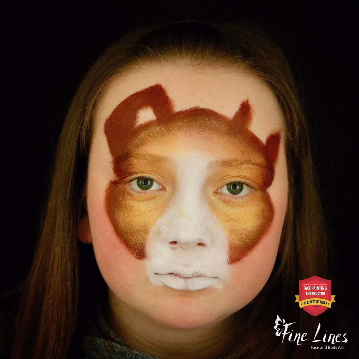 girl with brown face paint around the golden paint on her eyes and the outline of the dog ears on her forehead