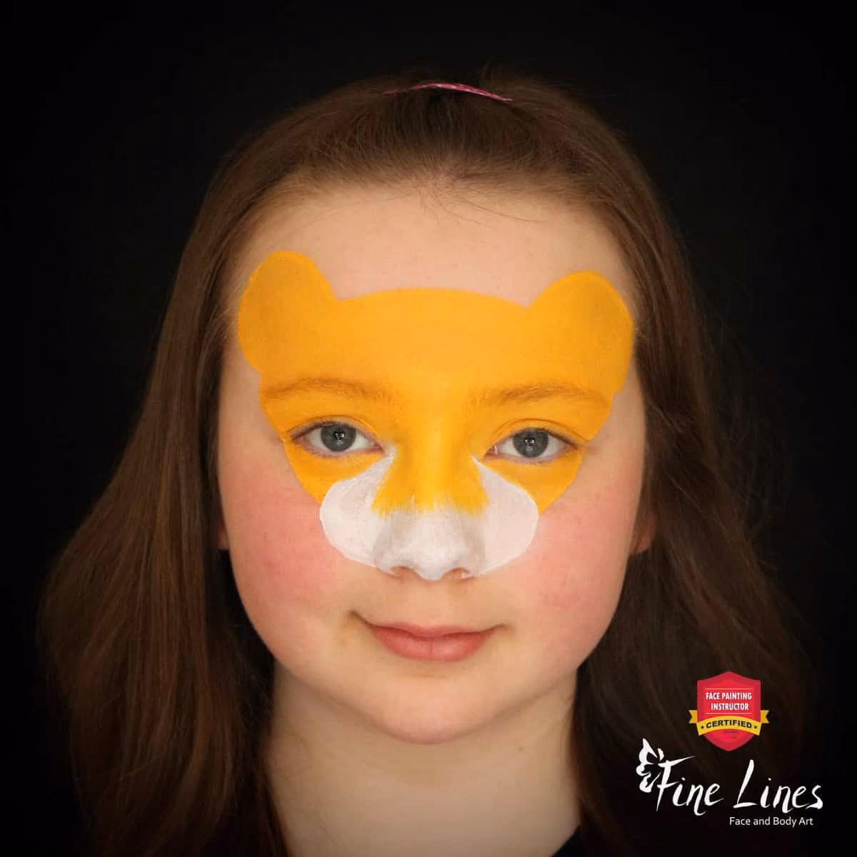 a girl with a base of a lion face paint design without a mane on her