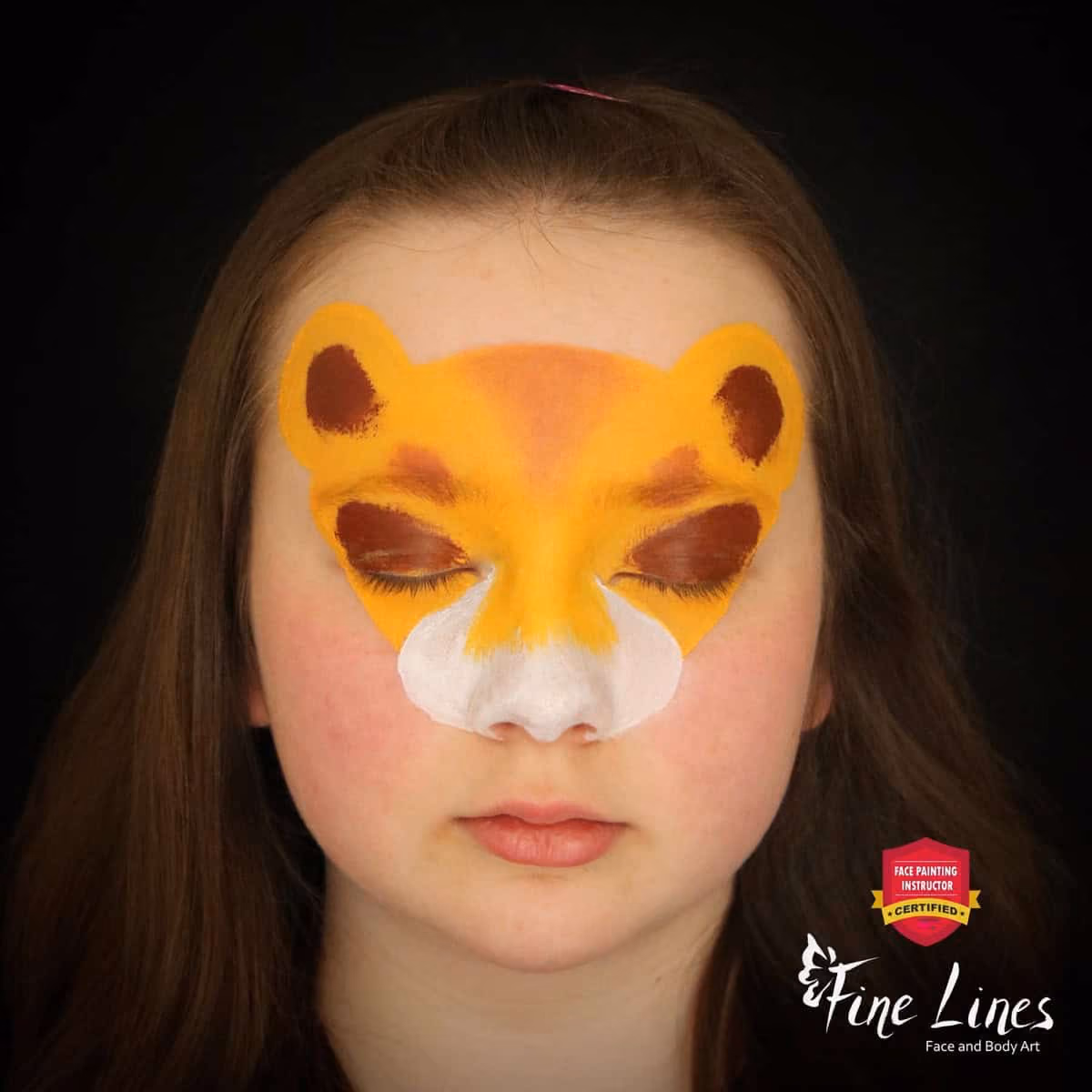 a girl with a base of a lion face paint design on her face