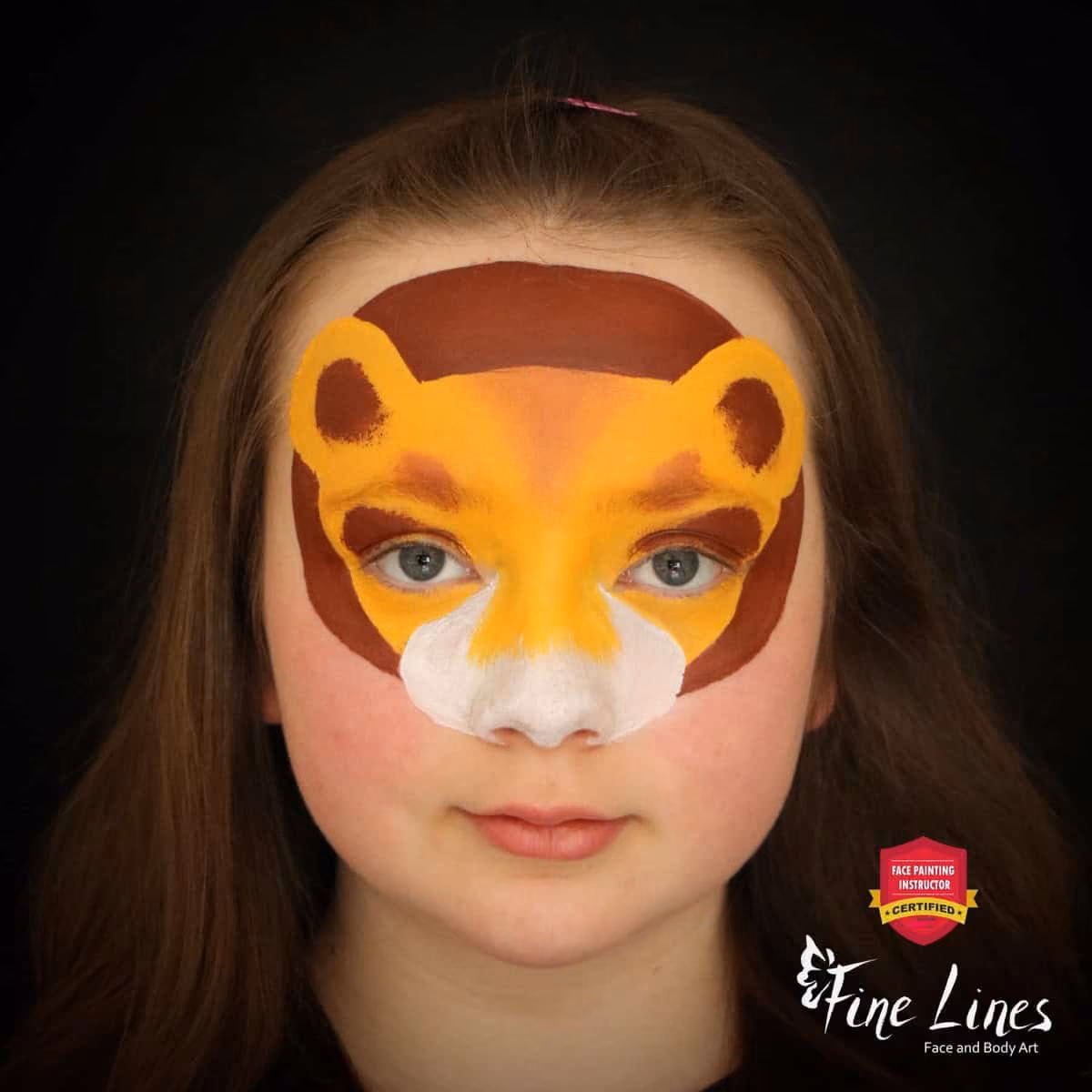 a girl with a compleated base of a lion face paint design on her
