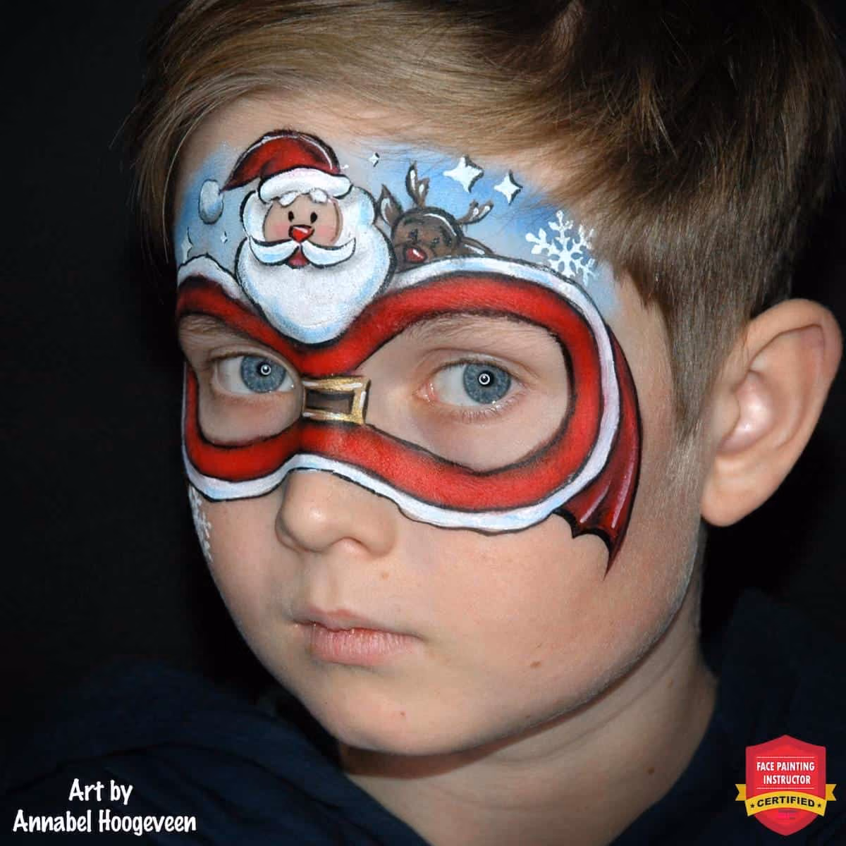 a boy with chirstmas santa clause face paint arount his eyes at an angle
