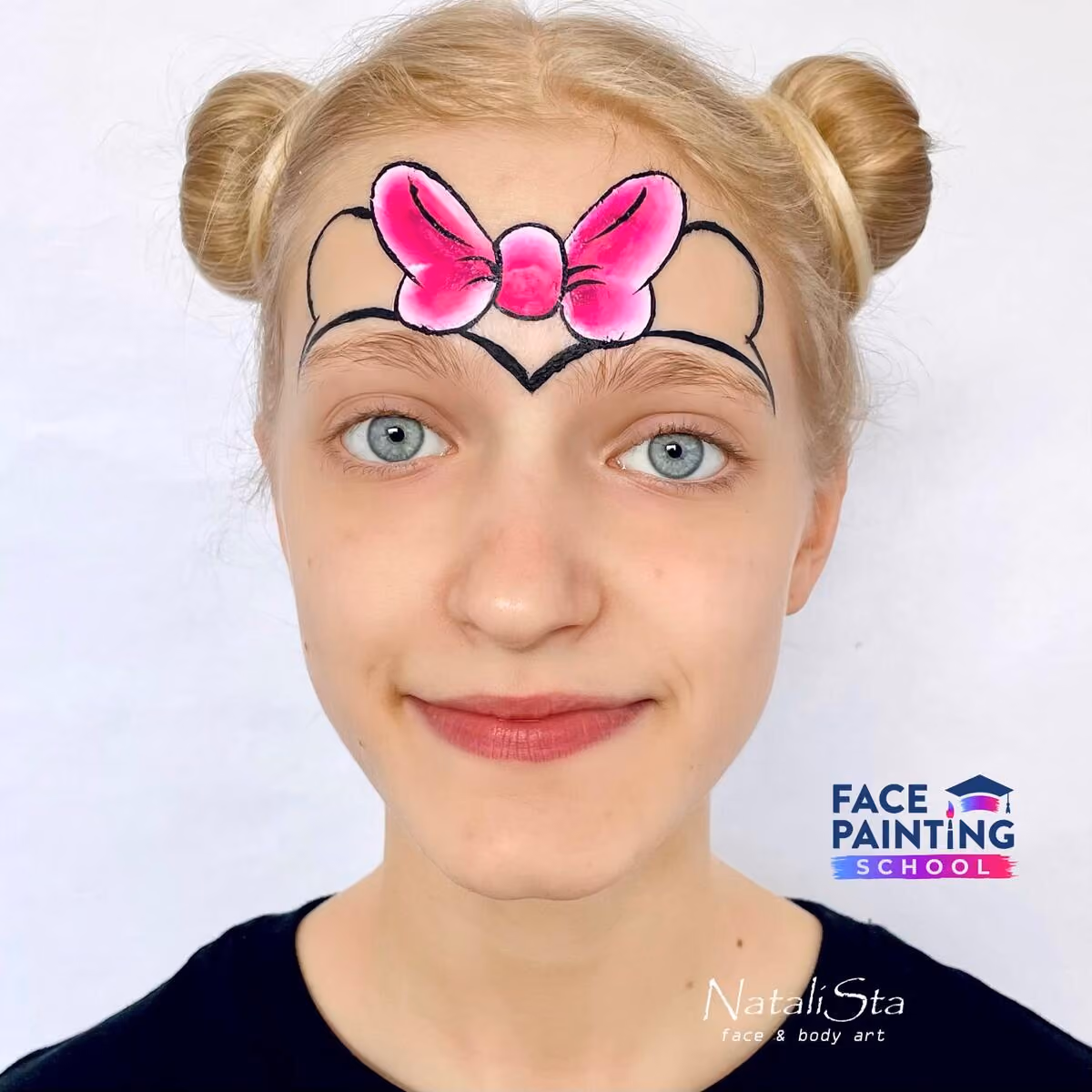 a girl with a detailed pink bow and minnie mouse ears outline painted on her face