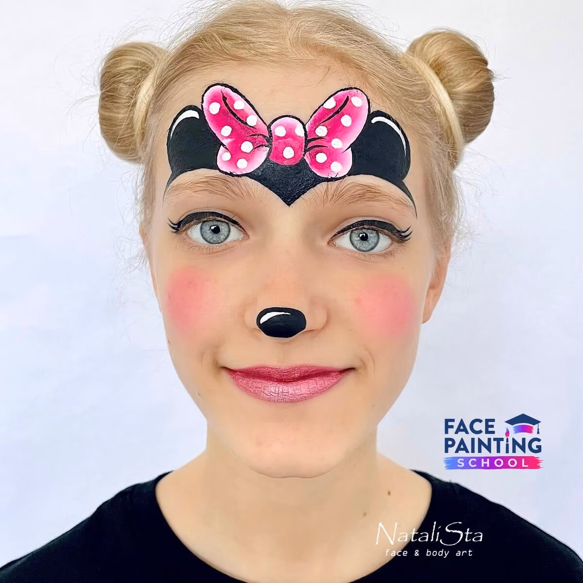 a girl with a completed cute minnie mouse face paint design