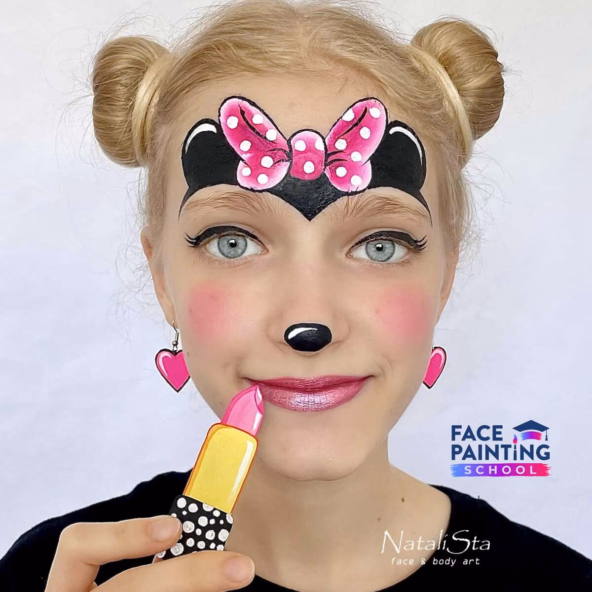a girl with a finished cute minnie mouse face paint design applying lipstick