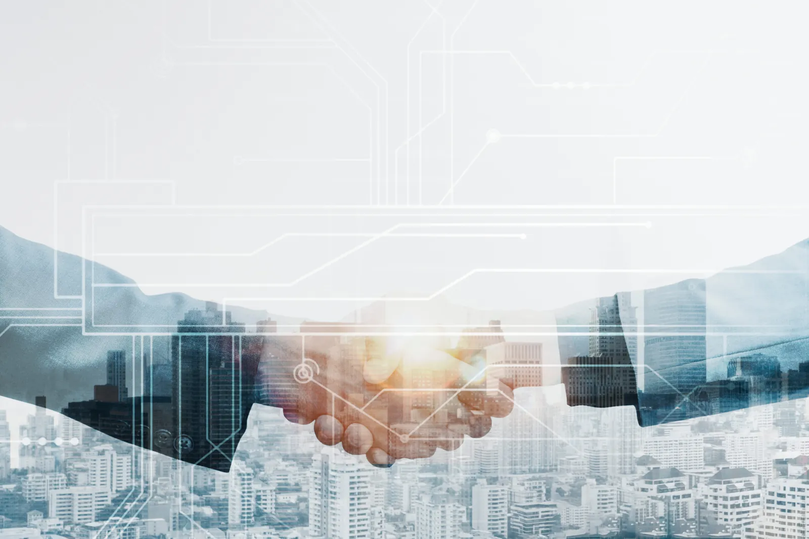 Business handshake over a city skyline with circuit lines
