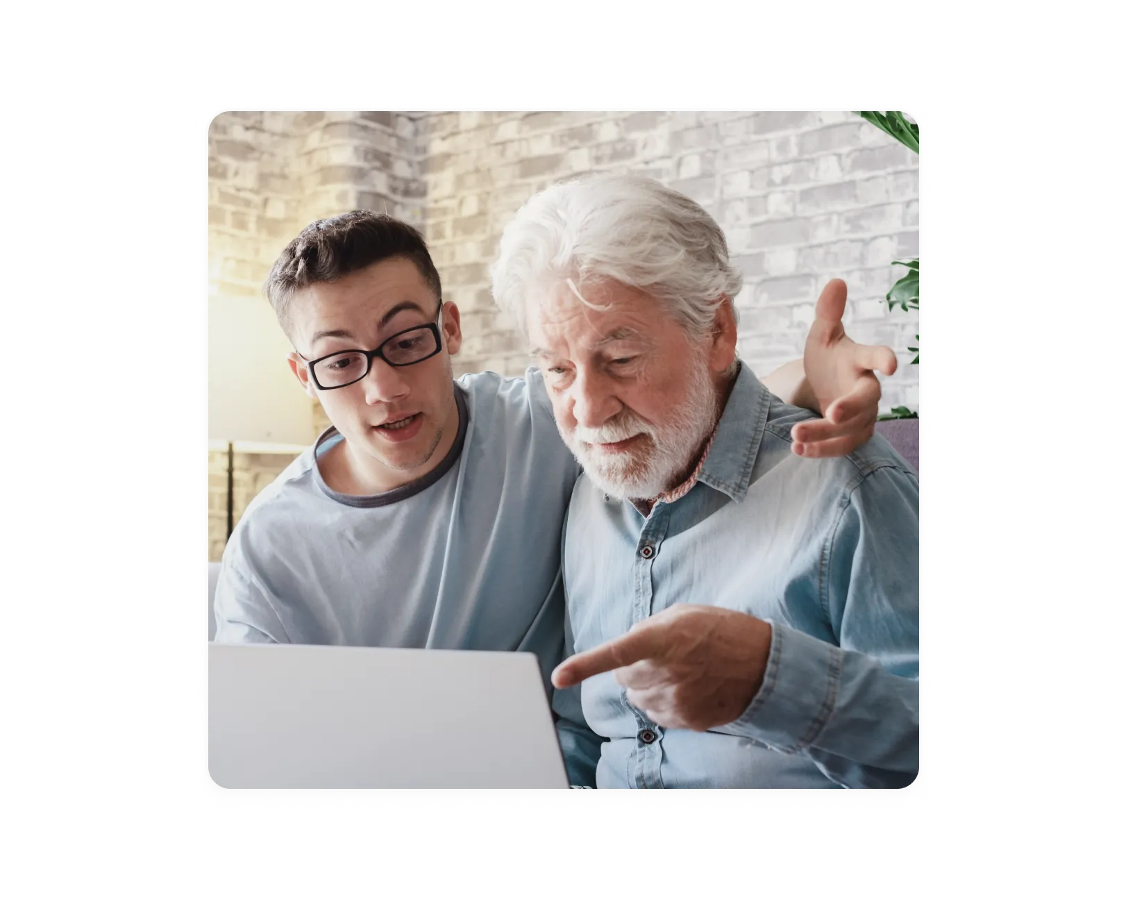 Two people reviewing a document - An older person with white hair and a younger person looking together at a document or tablet, suggesting a collaborative work or mentoring scenario. 