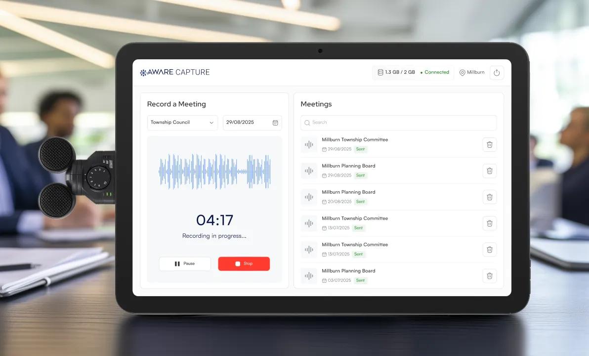 Tablet displaying a meeting recording interface - A tablet rests on a conference table, displaying a screen with an audio waveform, a timer showing "04:17", a record button, and a list of meeting participants.