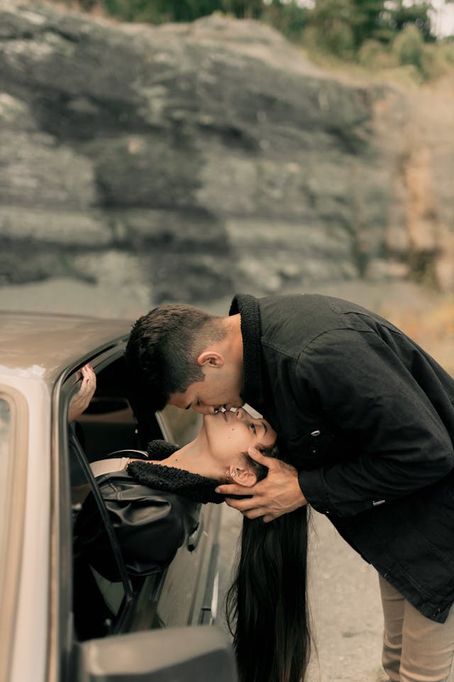 Couple en voiture s'embrassant tendrement, ambiance romantique