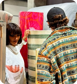 A picture of two people handling textile materials