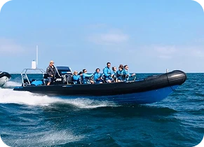 A picture of a group of people riding a boat on the sea