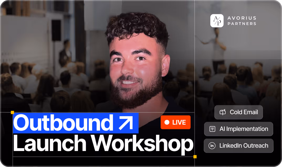 Smiling man with curly hair in front of a blurred audience at a live Outbound Launch Workshop by Avorius Partners.
