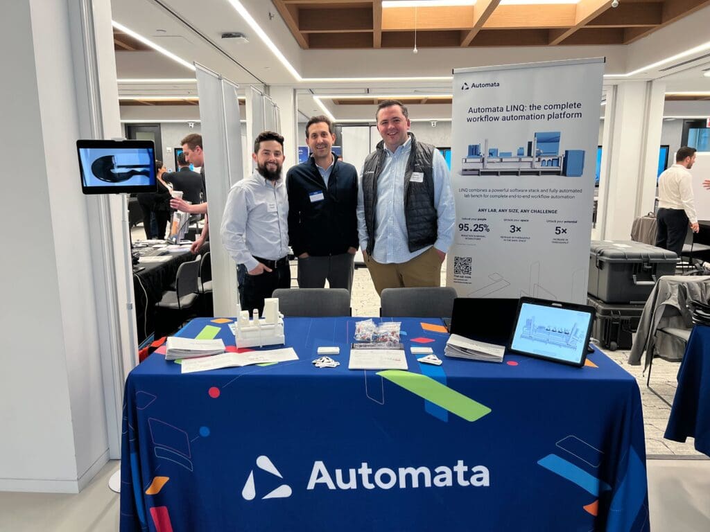 Brandon Revelli, Richard Grochmal and Bobby Driscoll are stood behind Automata's table at LRIG-NYC. They all look pretty happy to be there.