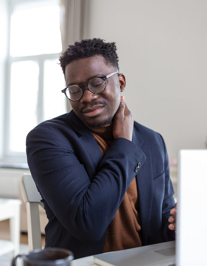Man rubbing his neck due to neck pain