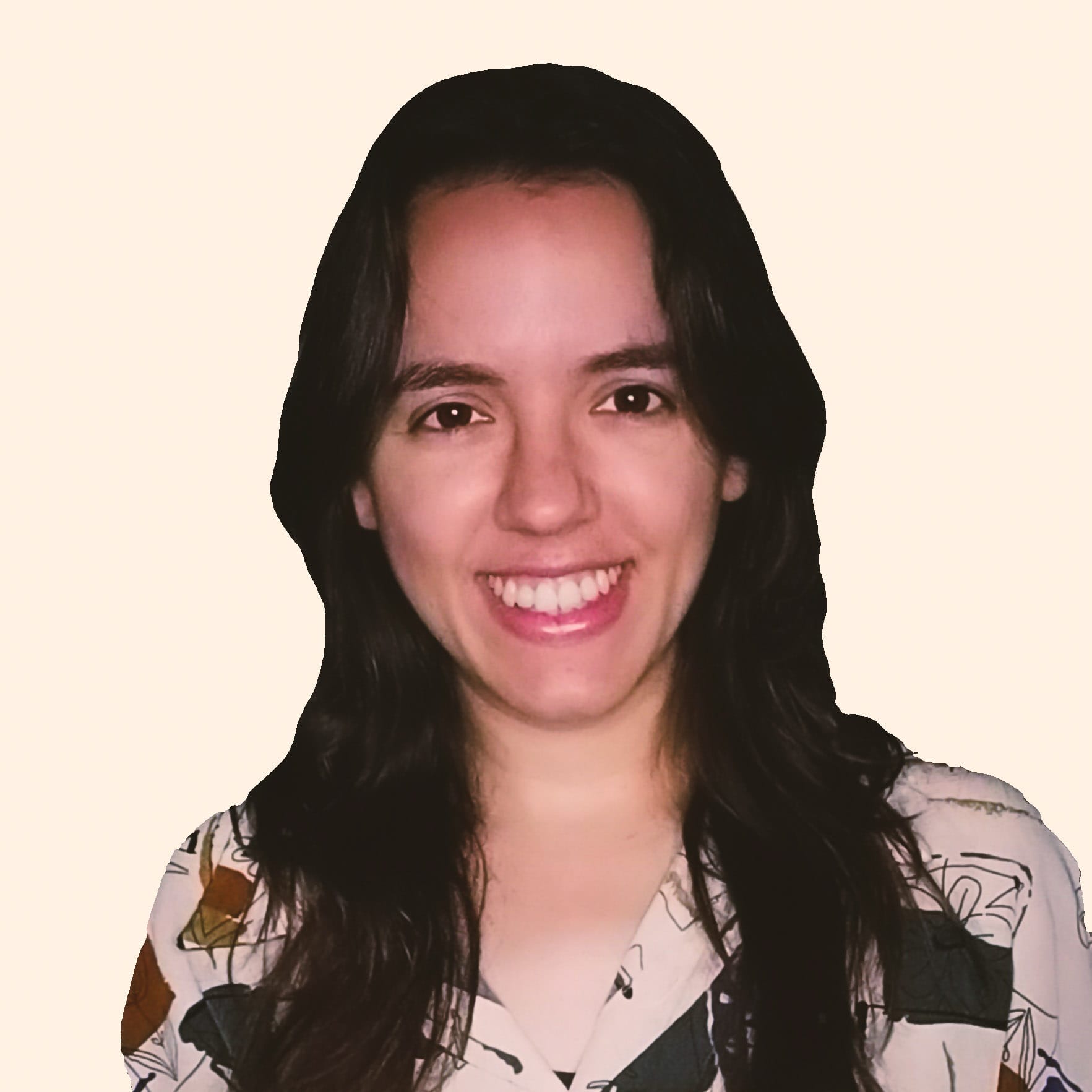 Smiling woman with long dark hair wearing a patterned shirt against a light background.