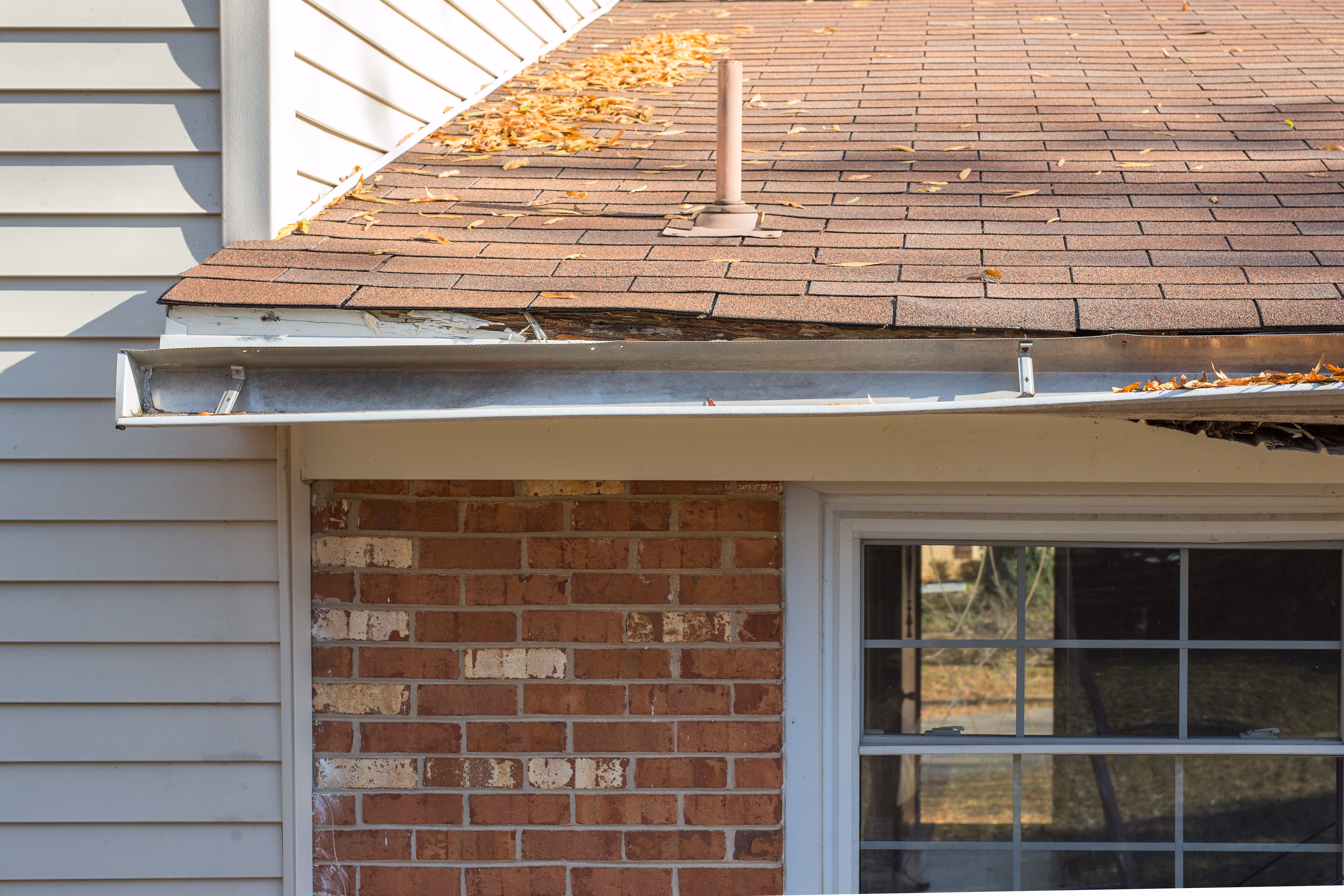 Before and after of a professional gutter replacement, removing old sagging troughs for a new seamless system.