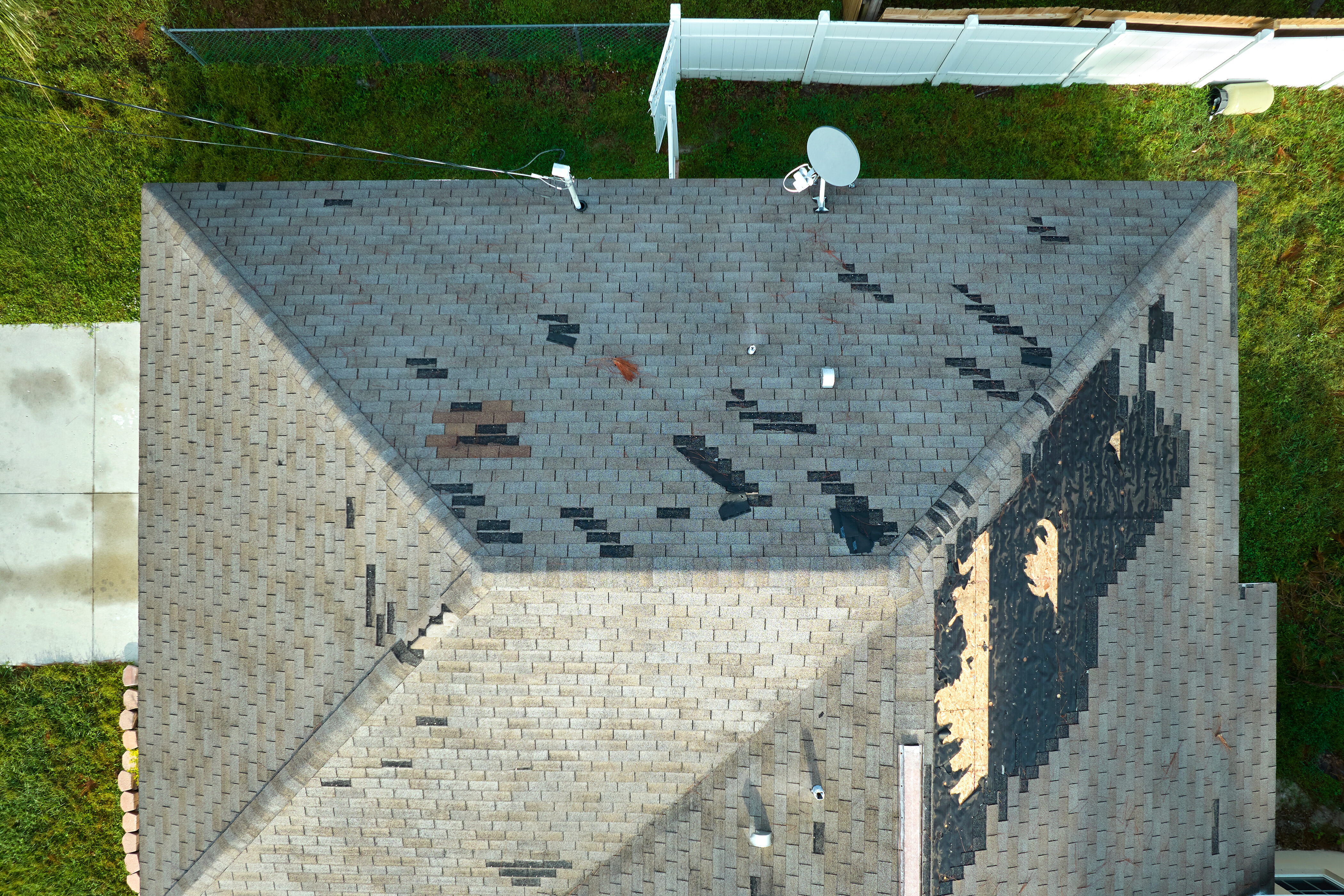 Close-up of hail-damaged roofing shingles identified during a free inspection in Southeastern Wisconsin.