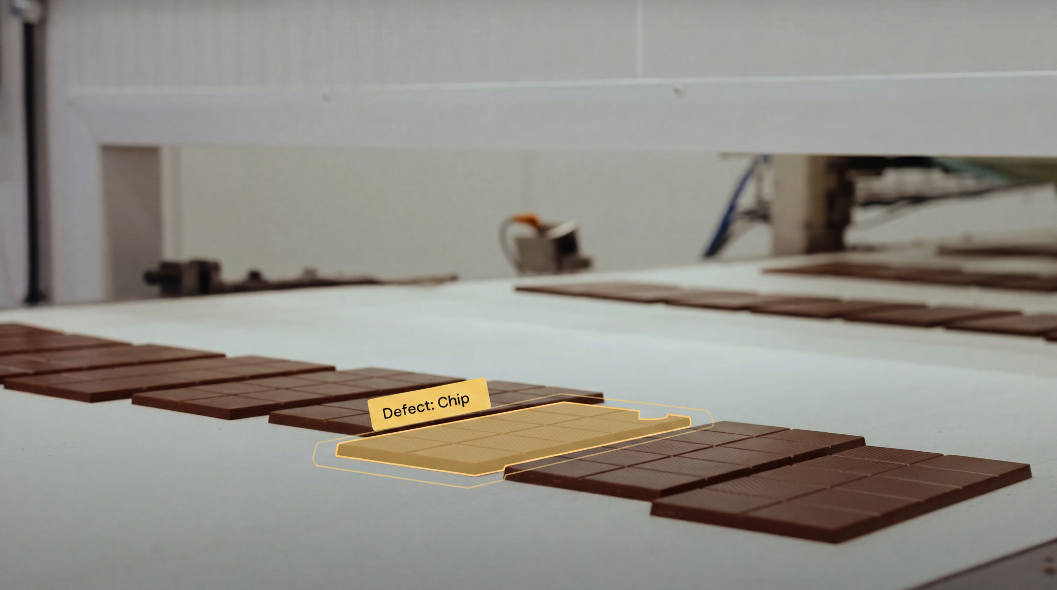 Maneva VITA AI quality control system detecting a defect on a chocolate bar on a confectionery production line