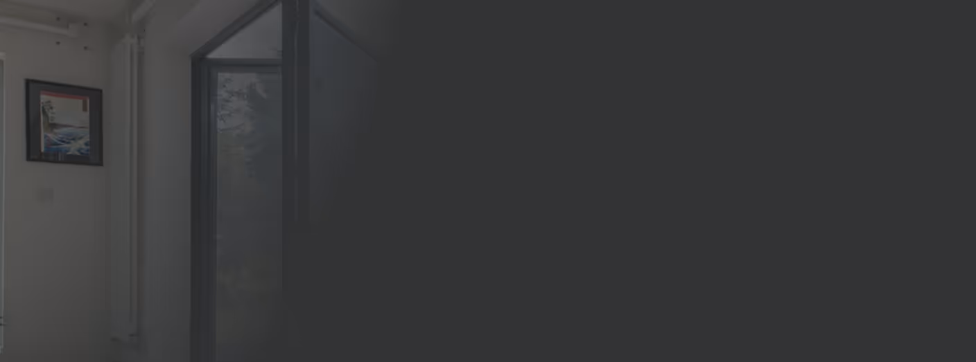 Open door in a modern room showing a foggy outdoor scene with trees.