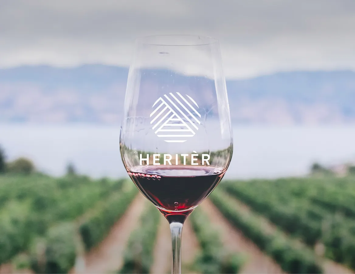 Logo Heritèr (société de négoce en vin) sur un verre de vin