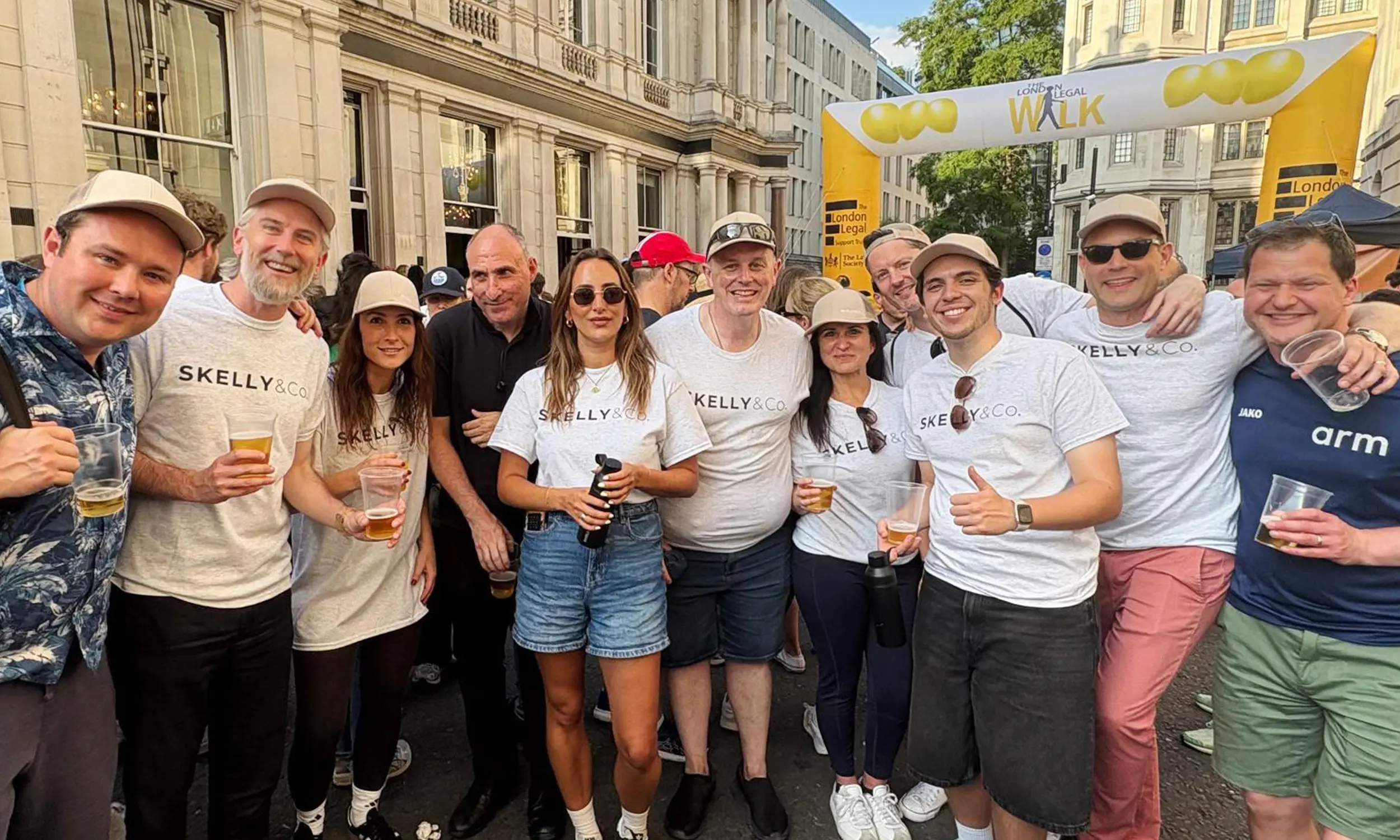 The team posing after completing the London Legal Walk 2025 at the finish line in the summer evening