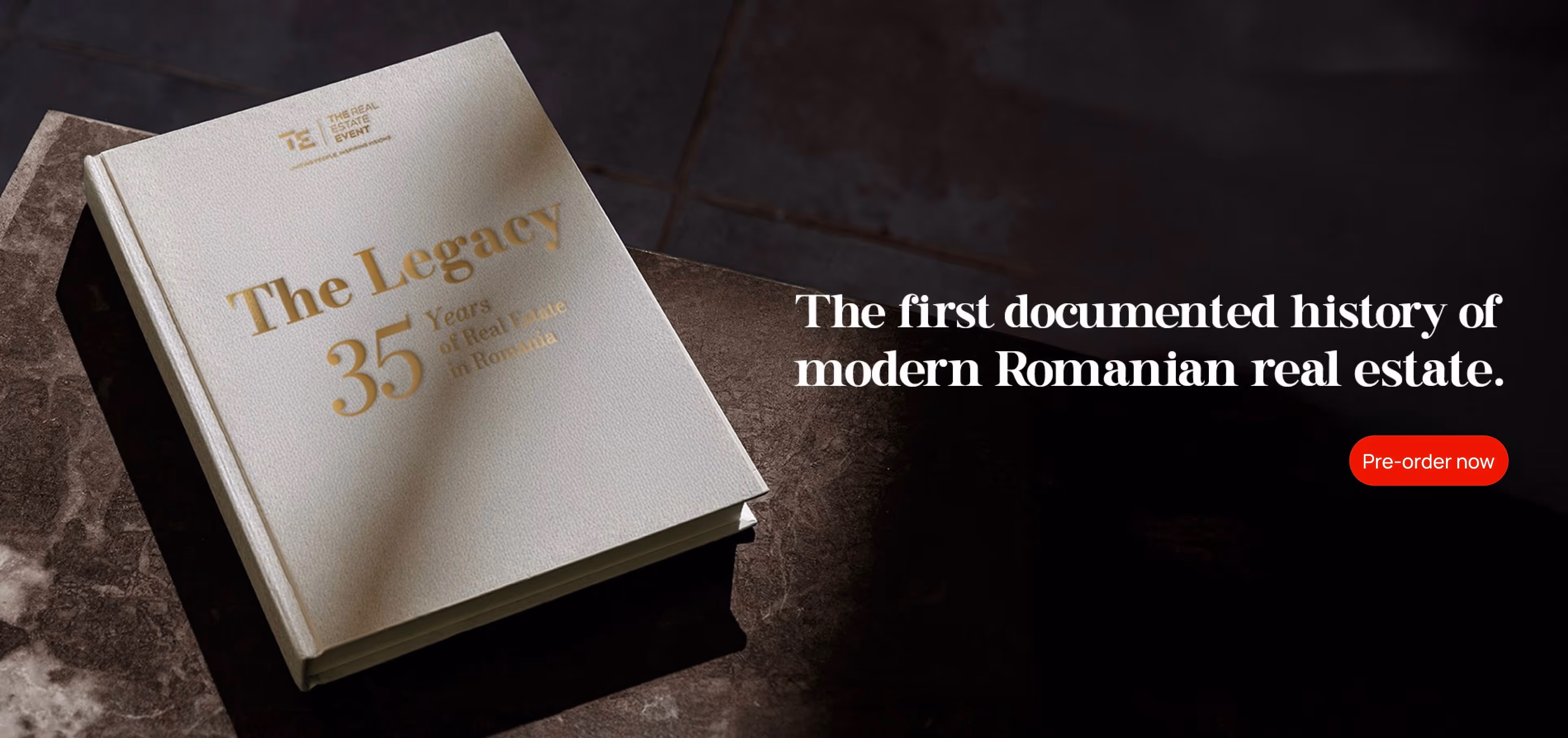 Book titled 'The Legacy 35 Years of Real Estate in Romania' placed on a stone surface beside text about the first documented history of modern Romanian real estate and a red 'Pre-order now' button.