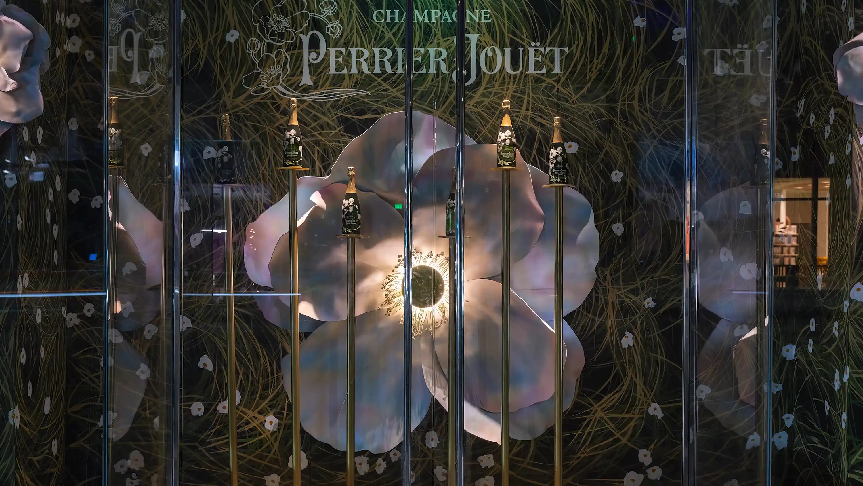 A perrier jouet storefront with flowers and champagne. 