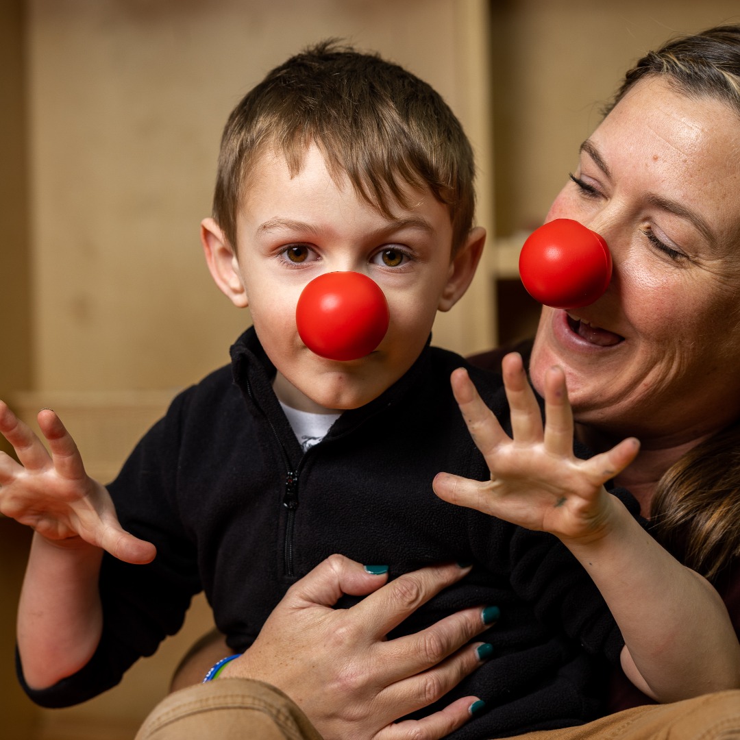 Young boy and his mom wearing Red Noses.