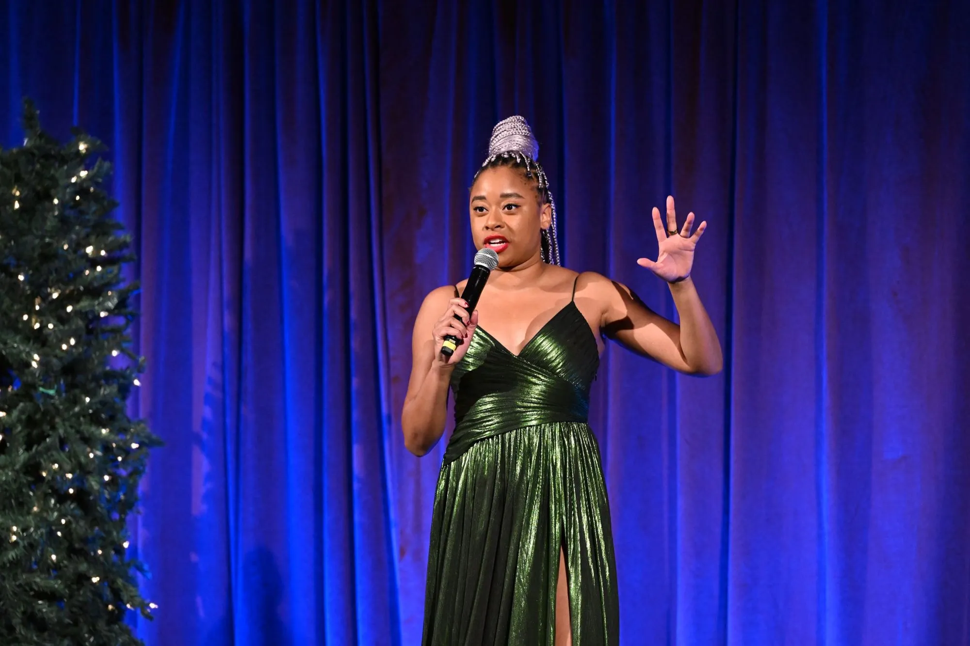 Group of children smiling and wearing red noses, with one boy making a peace sign.