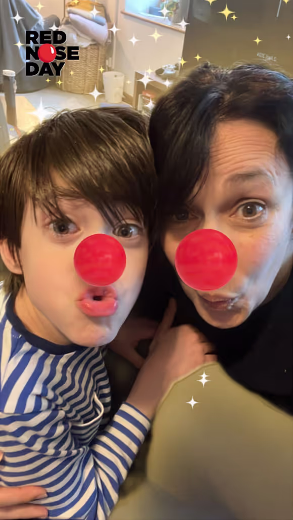 Two children with red clown noses making silly faces, one child in striped shirt, with Red Nose Day logo.