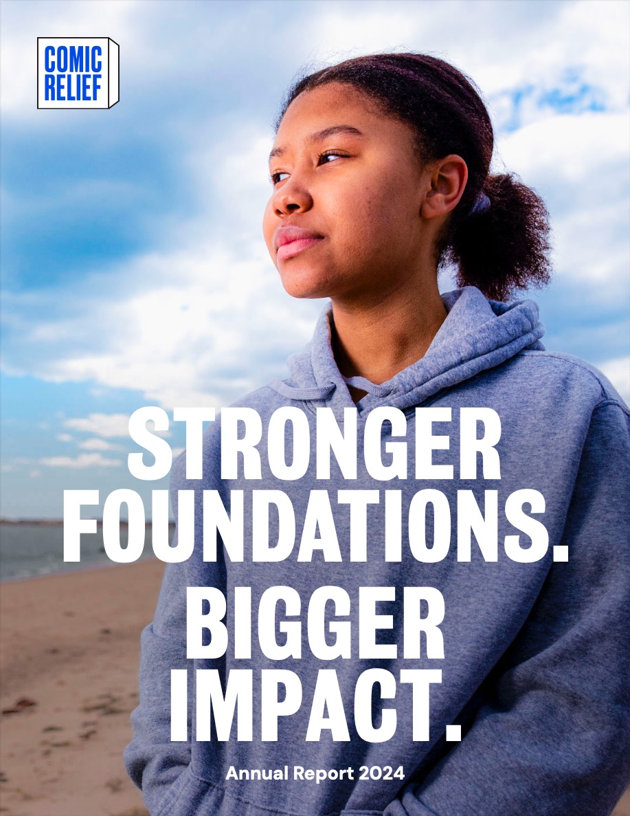 Young person in a gray hoodie looking thoughtfully toward the horizon with text 'Stronger Foundations. Bigger Impact. Annual Report 2024' and Comic Relief logo.